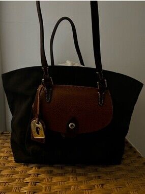 Dooney & Bourke Classic Black Tote with Brown Leather Flap.. Spots On Interior.